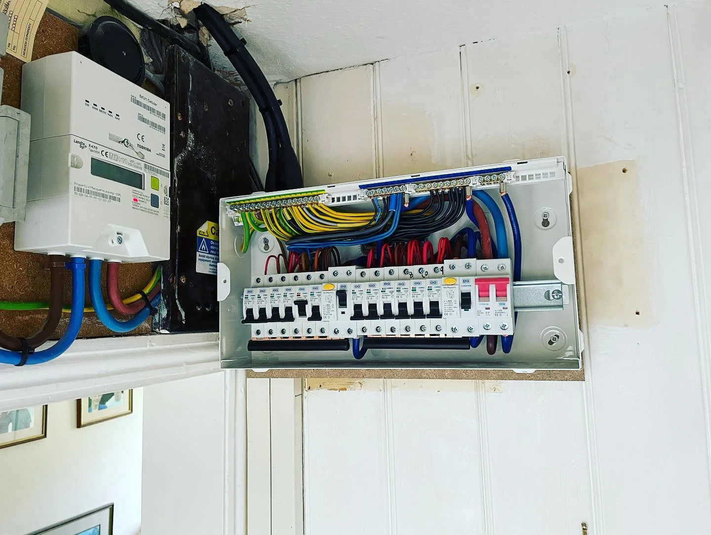Professional electrician working on fuseboard